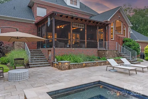 a view of a chair and table in backyard of the house