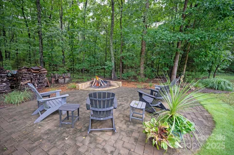 a view of a patio with table and chairs potted plants with wooden floor and fence