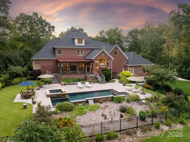 a front view of a house with yard patio and green space