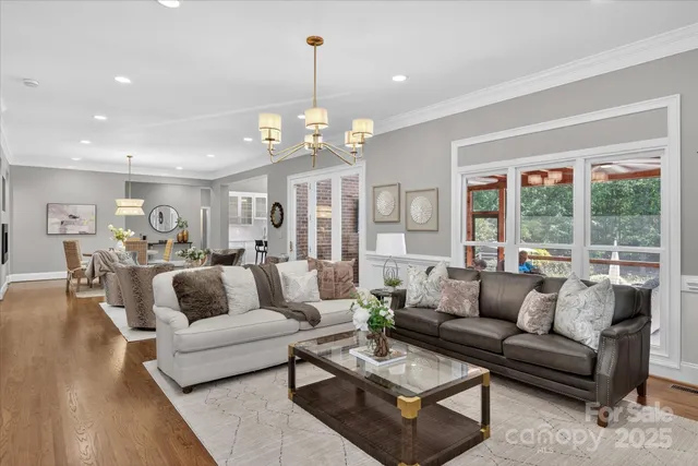 a living room with furniture or couches and a dining table with wooden floor