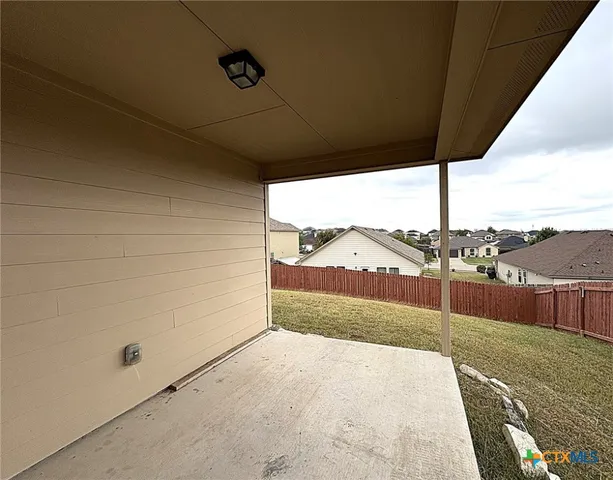 a view of a house with wooden fence