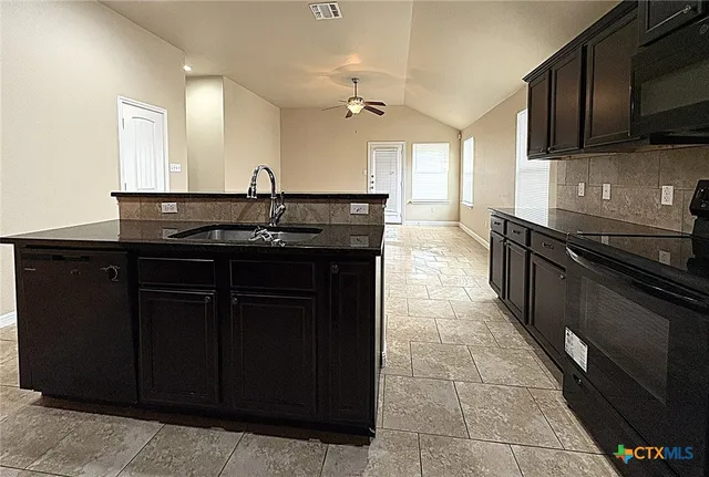 a kitchen with a sink and cabinets