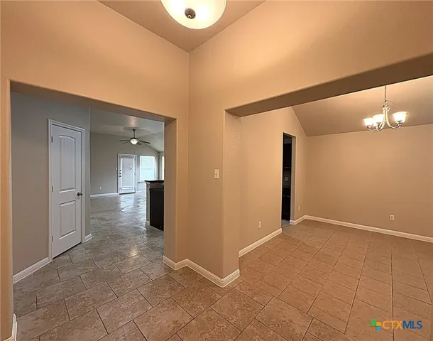 a view of an empty room with a ceiling fan