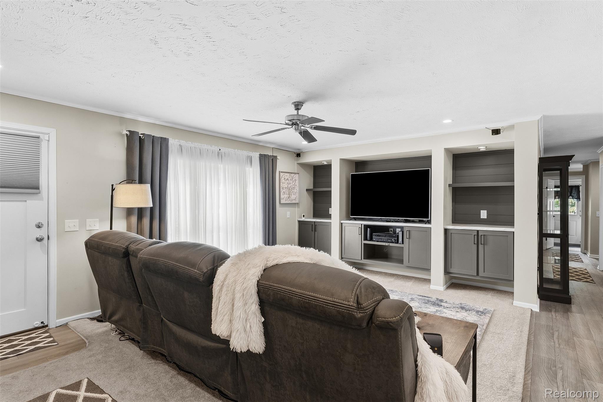 6450 Prince Boulevard Fenton, MI 48430 - Photo 6 of 31 Living room featuring built-in media cabinetry with shelving, recessed lighting, and a ceiling fan
