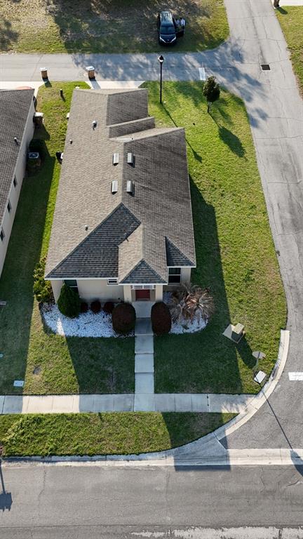 3100 Rocky River Road Kissimmee, FL 34746 - Photo 2 of 33 an aerial view of a house with a yard and potted plants