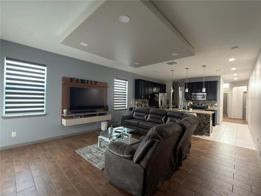 3100 Rocky River Road Kissimmee, FL 34746 - Photo 22 of 33 a living room with furniture and a flat screen tv