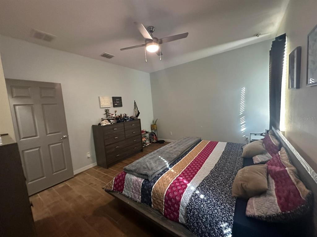 3100 Rocky River Road Kissimmee, FL 34746 - Photo 27 of 33 a bedroom with a bed and dresser