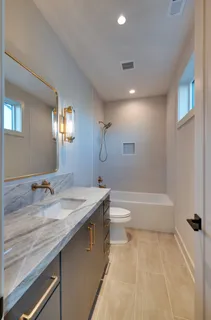 a en suite bathroom with a sink and a mirror
