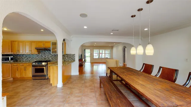a spacious bathroom with a granite countertop sink a large mirror and a shower
