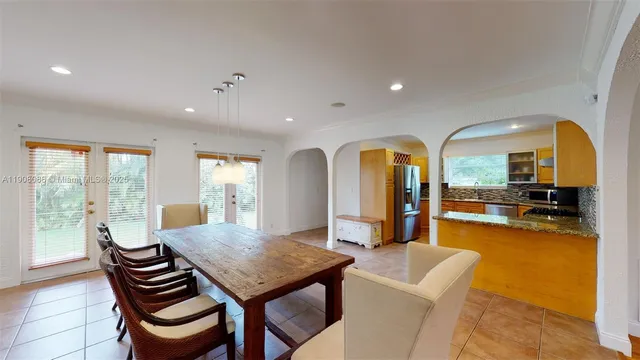 a view of a dining room with furniture window and outside view
