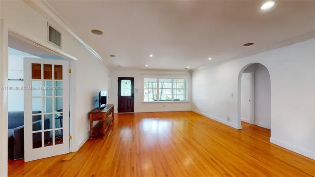 a view of empty room with wooden floor