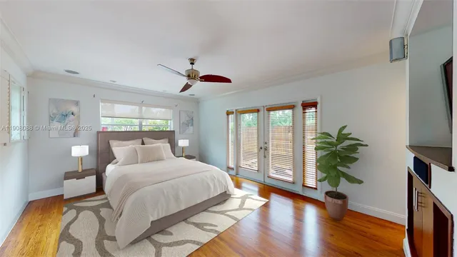 a bedroom with a large bed and a large window with wooden floor