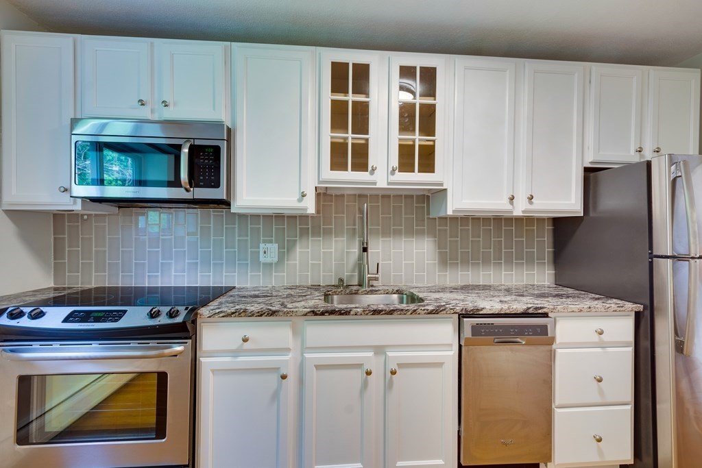 41 Westgate Road, Unit 3 Chestnut Hill, MA 02467 - Photo 1 of 18 a kitchen with stainless steel appliances granite countertop a stove and a refrigerator