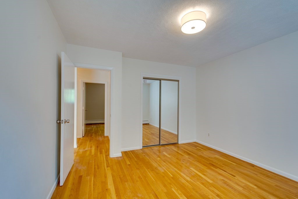41 Westgate Road, Unit 3 Chestnut Hill, MA 02467 - Photo 13 of 18 a bedroom with a bed and a table