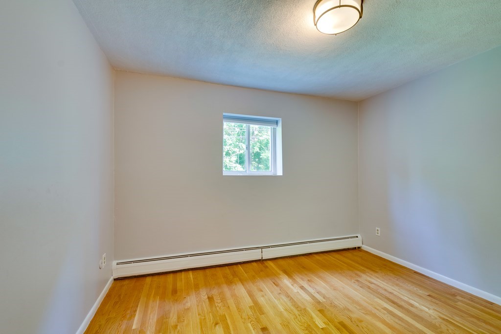 41 Westgate Road, Unit 3 Chestnut Hill, MA 02467 - Photo 14 of 18 a view of a room with wooden floor and small window