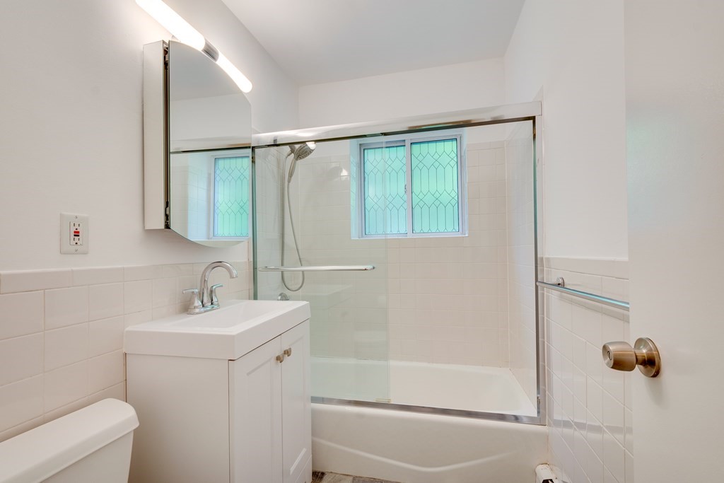 41 Westgate Road, Unit 3 Chestnut Hill, MA 02467 - Photo 16 of 18 a bathroom with a sink toilet and shower