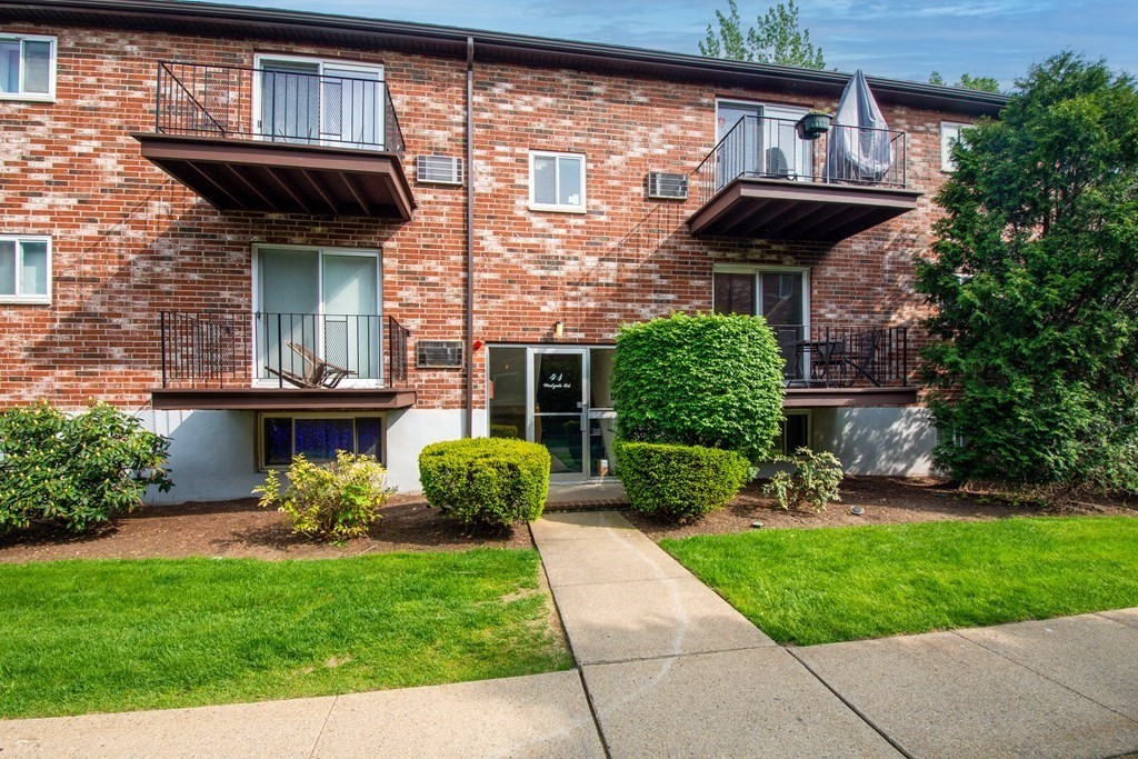41 Westgate Road, Unit 3 Chestnut Hill, MA 02467 - Photo 4 of 18 a view of a house with a small yard and a large tree