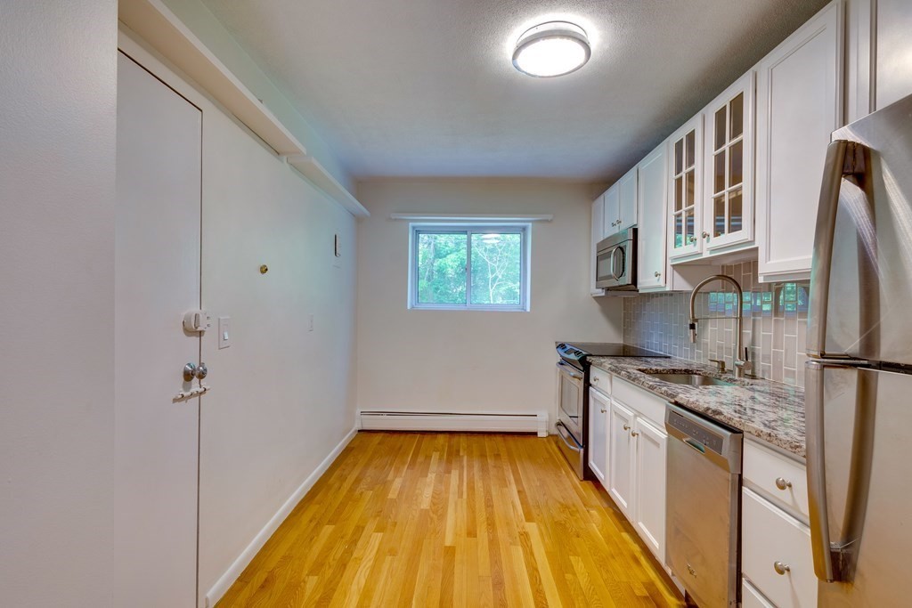 41 Westgate Road, Unit 3 Chestnut Hill, MA 02467 - Photo 10 of 18 a kitchen with a sink a refrigerator and window