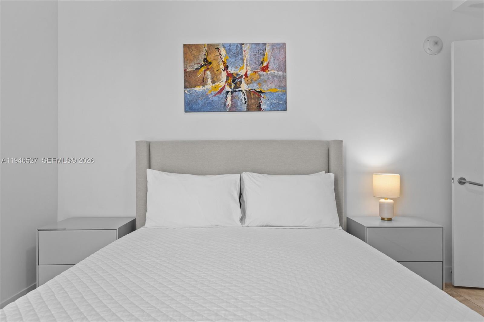 239 Southwest 9th Street, Unit 2304 Miami, FL 33130 - Photo 11 of 35 a bedroom with a bed and painting on the wall