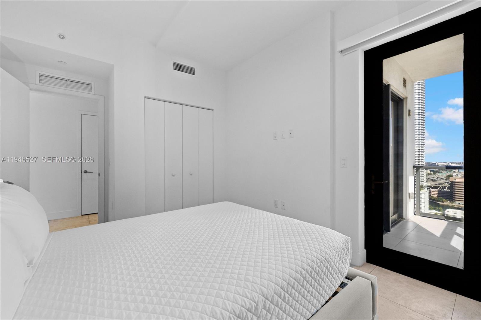 239 Southwest 9th Street, Unit 2304 Miami, FL 33130 - Photo 12 of 35 a bedroom with a bed and a large window