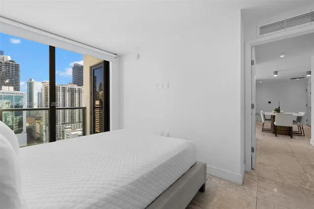 a bed room with a bed and a large mirror