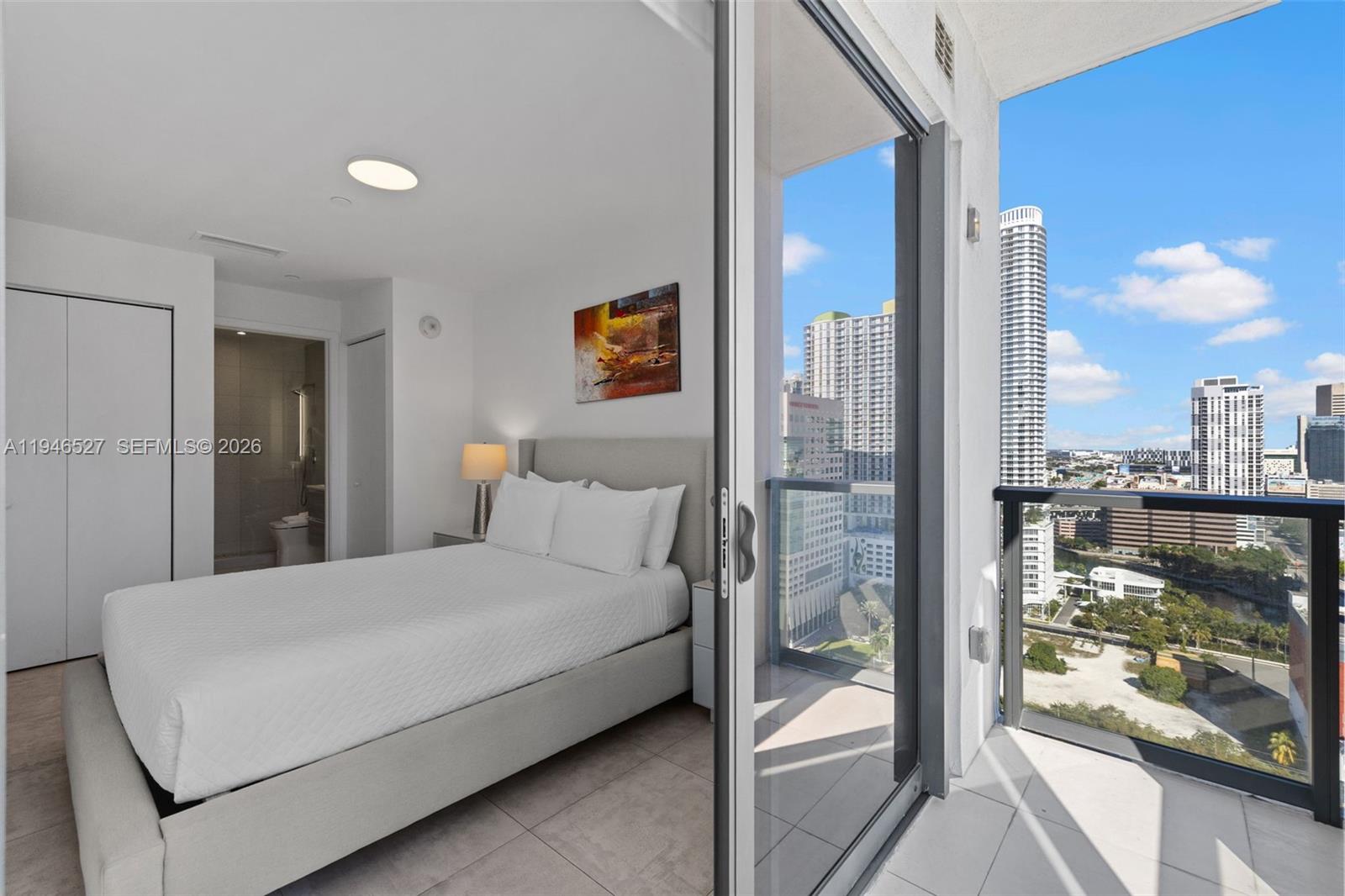 239 Southwest 9th Street, Unit 2304 Miami, FL 33130 - Photo 19 of 35 a bedroom with a large bed and a glass door shower