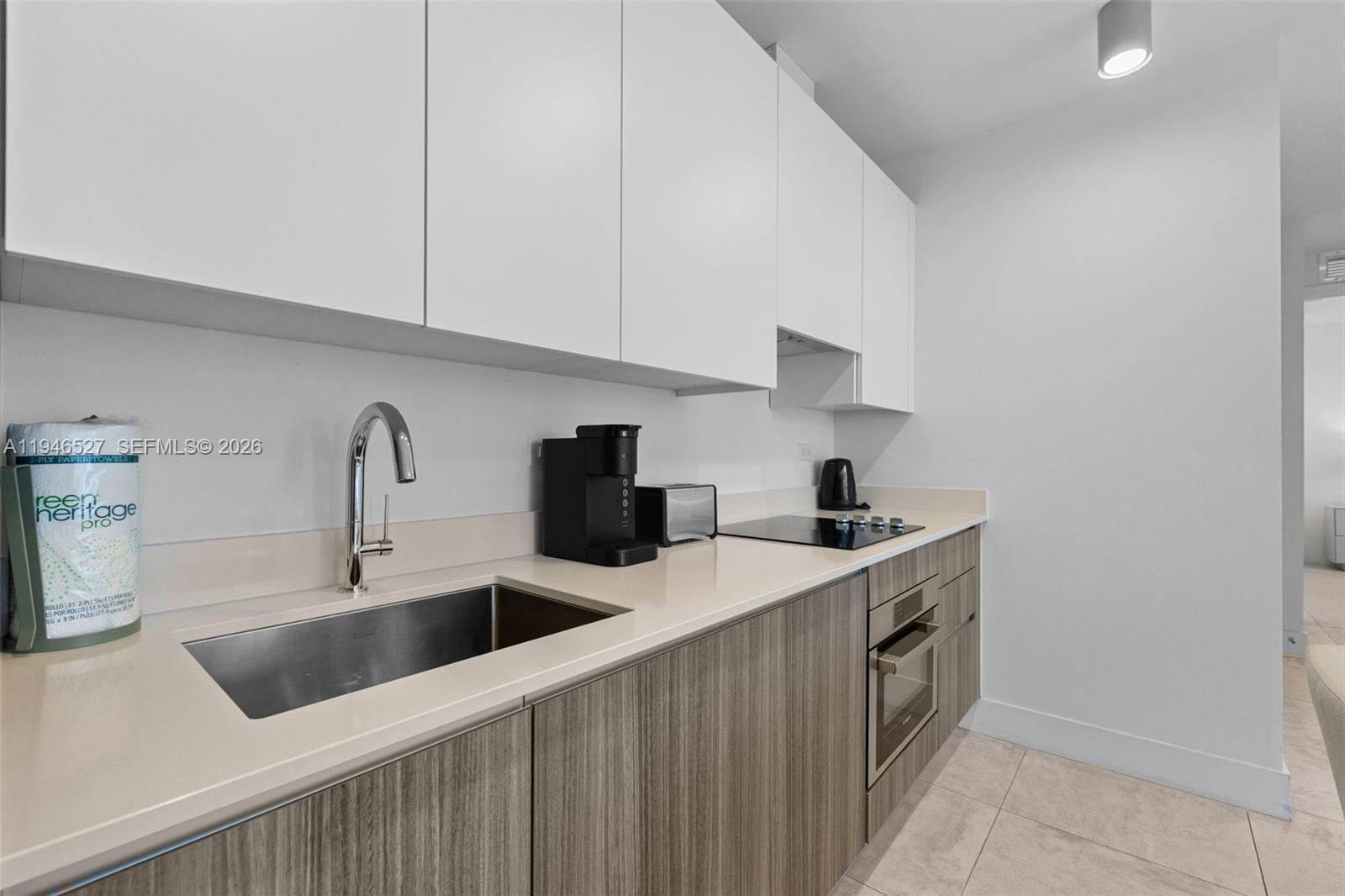 239 Southwest 9th Street, Unit 2304 Miami, FL 33130 - Photo 22 of 35 a kitchen with stainless steel appliances a sink a stove and refrigerator