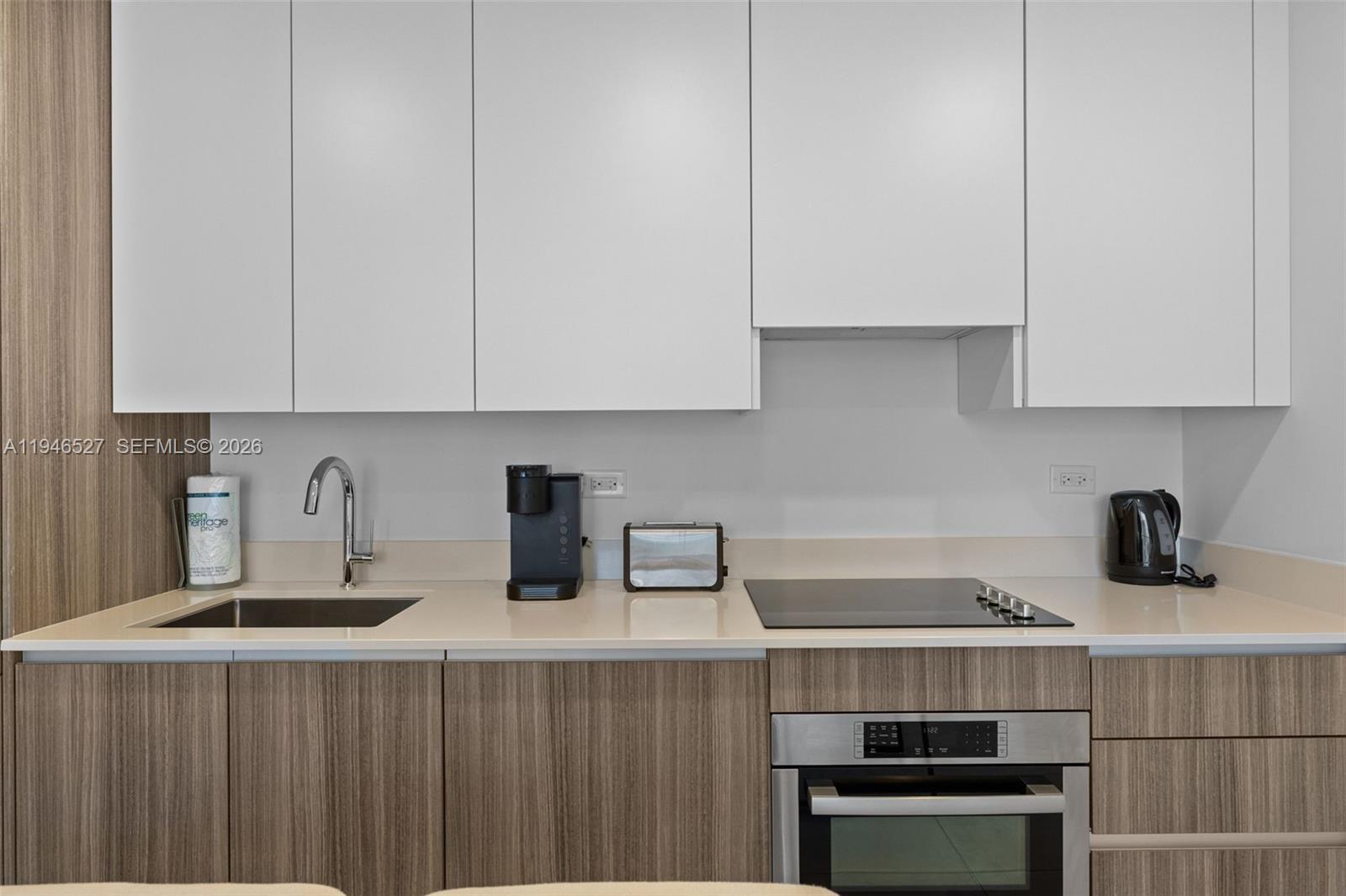239 Southwest 9th Street, Unit 2304 Miami, FL 33130 - Photo 23 of 35 a kitchen with a sink and cabinets