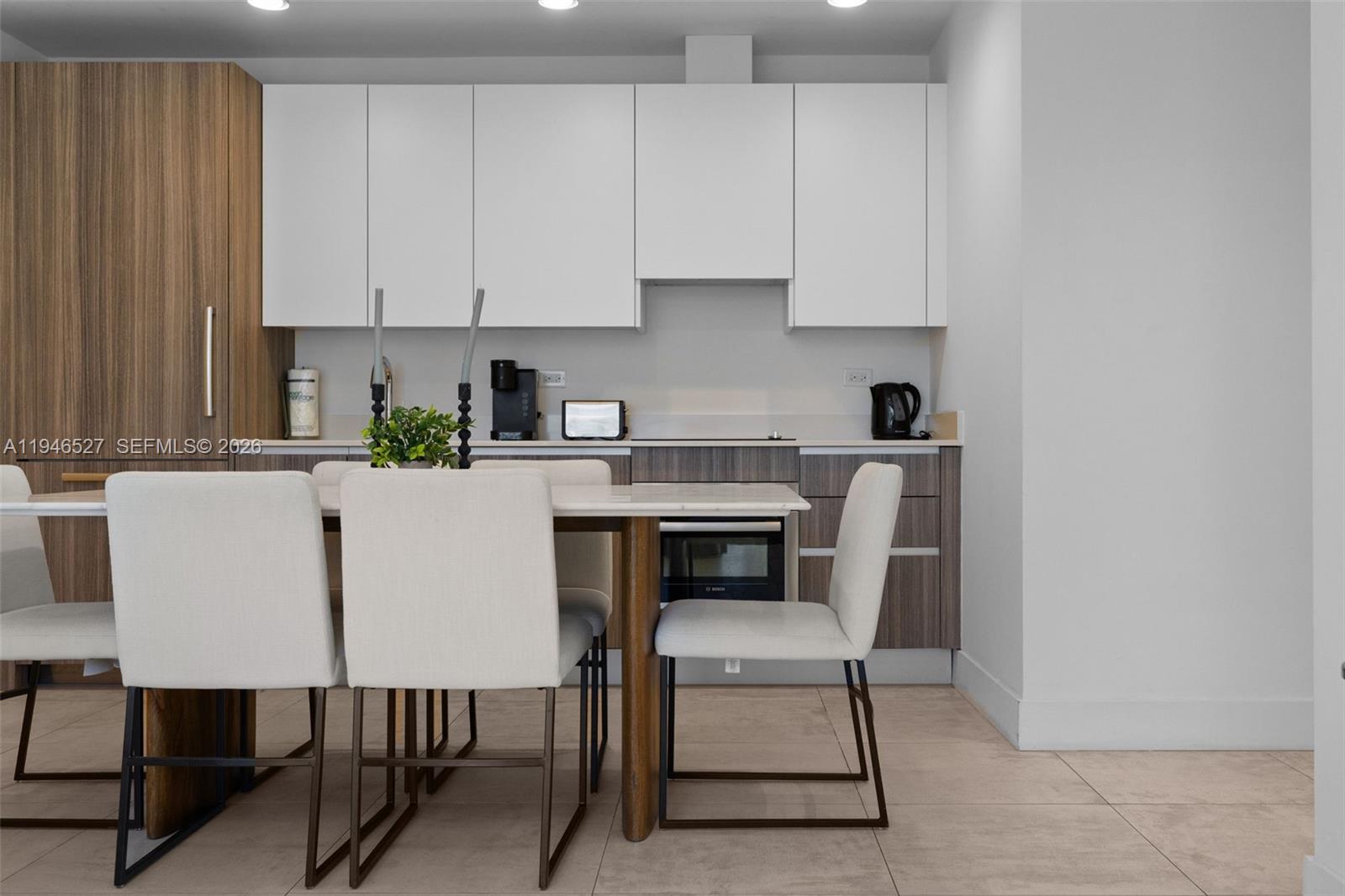 239 Southwest 9th Street, Unit 2304 Miami, FL 33130 - Photo 30 of 35 a kitchen with a dining table chairs and cabinets