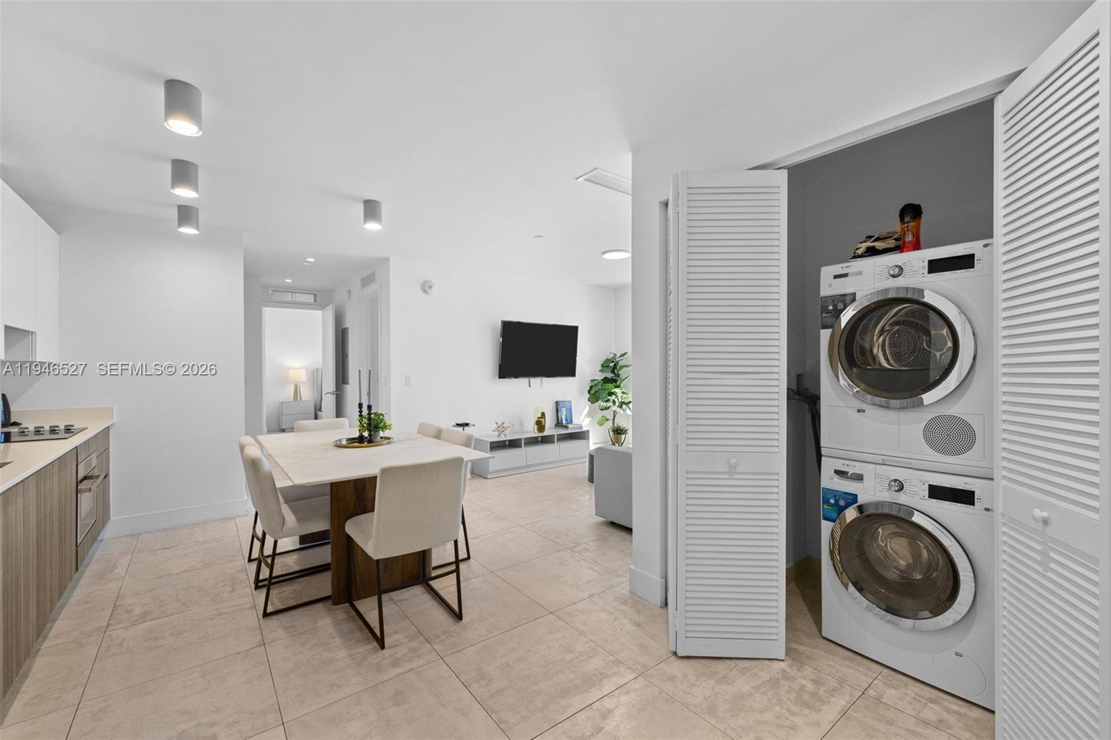 239 Southwest 9th Street, Unit 2304 Miami, FL 33130 - Photo 5 of 35 a view of a kitchen with a stove a washer and dryer