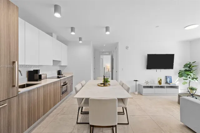 a kitchen with stainless steel appliances kitchen island granite countertop a sink and cabinets