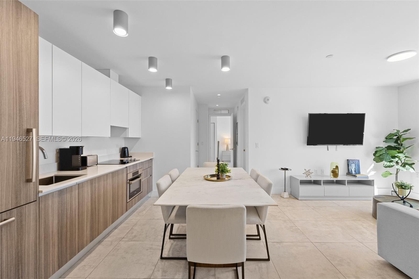 239 Southwest 9th Street, Unit 2304 Miami, FL 33130 - Photo 6 of 35 a kitchen with stainless steel appliances kitchen island granite countertop a sink and cabinets