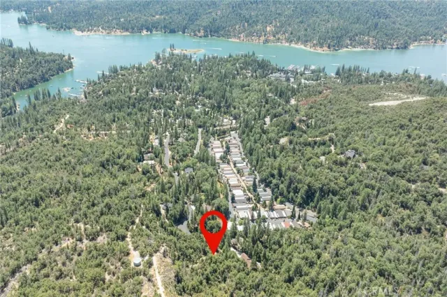 a view of a lake with a yard and mountain in the background