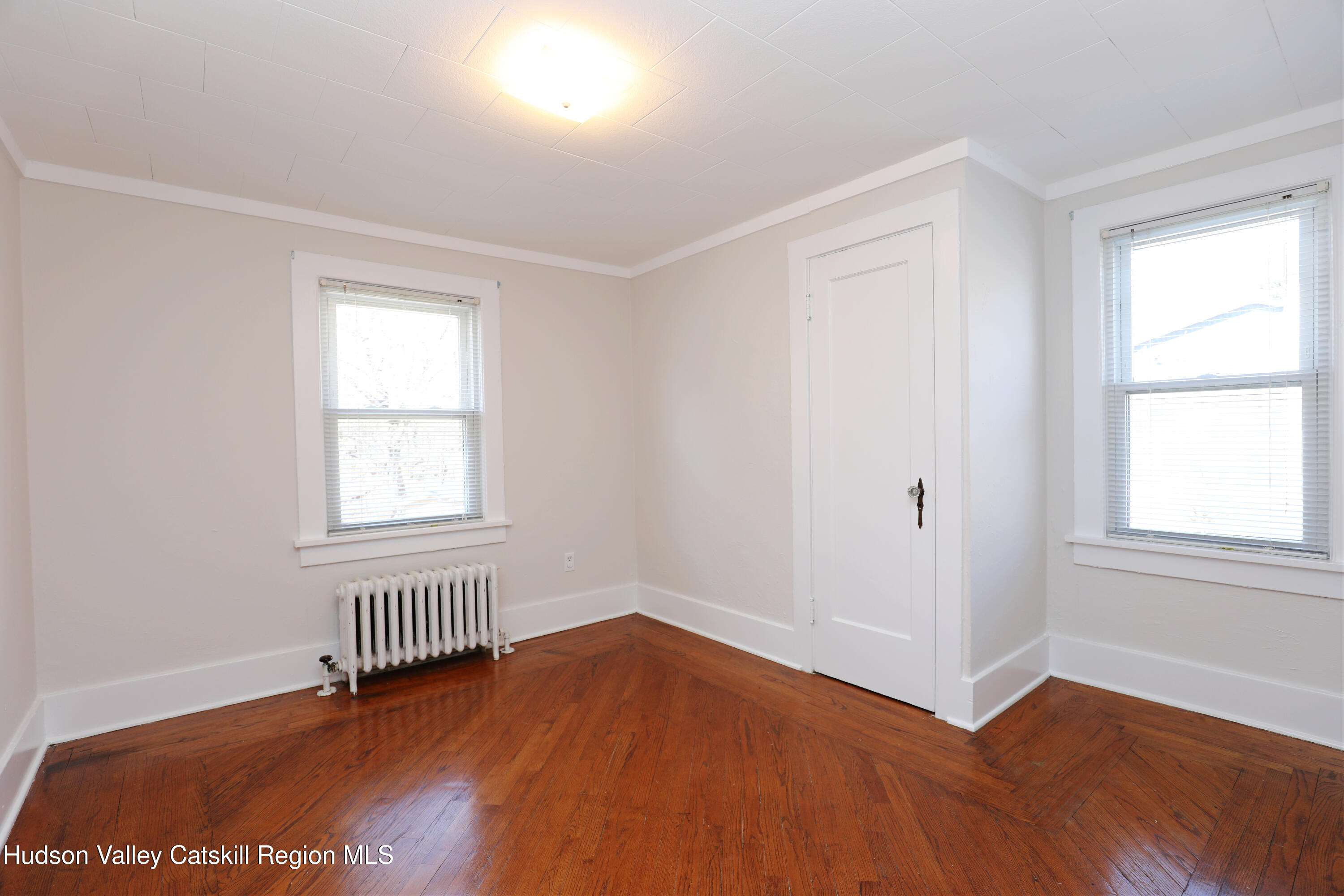 353 West Saugerties Road Saugerties, NY 12477 - Photo 17 of 21 an empty room with wooden floor and windows