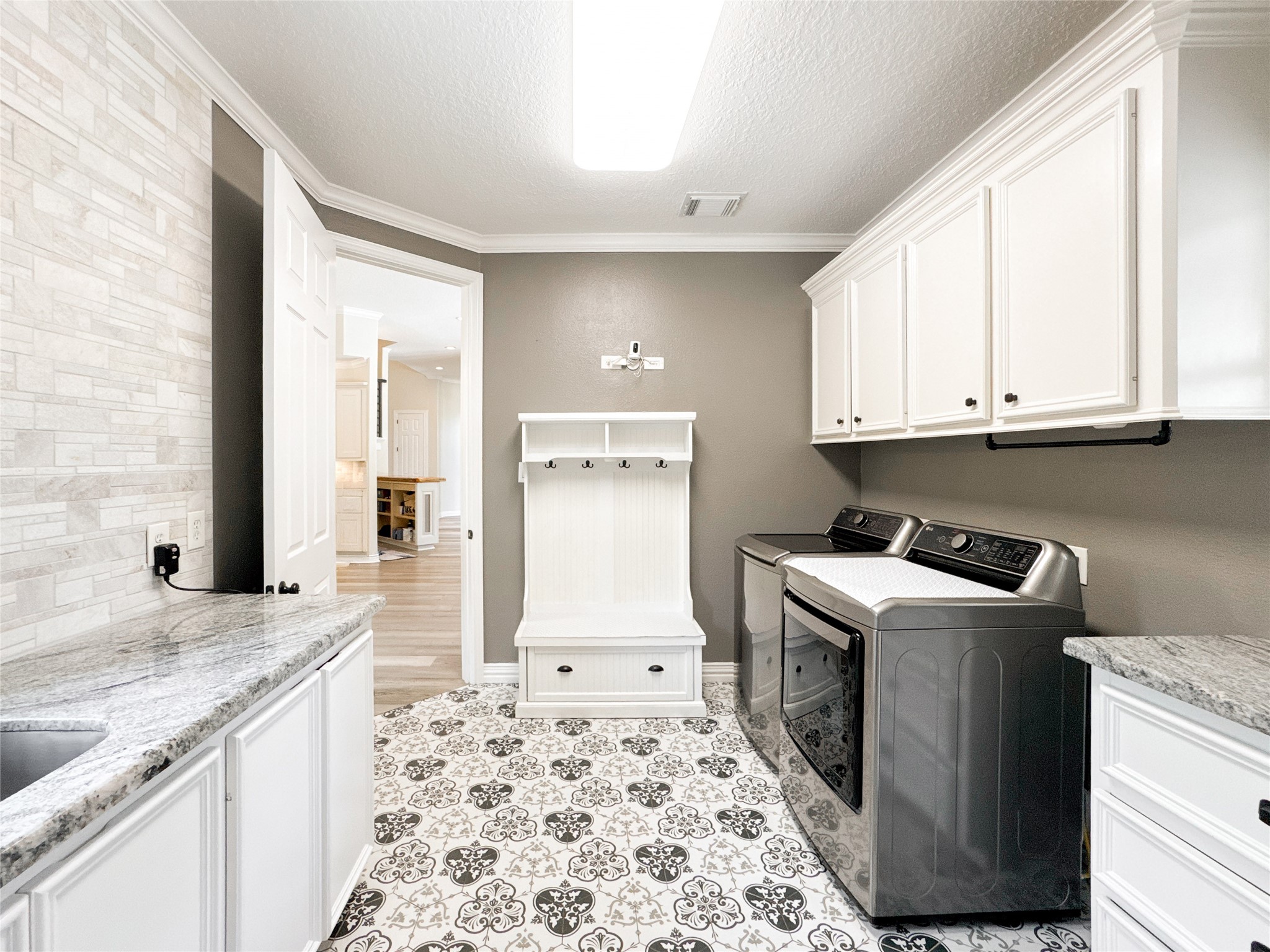 1810 Woerner Road Houston, TX 77090 - Photo 25 of 39 This stylish washroom features modern appliances, ample storage with elegant cabinetry, and a sleek countertop, offering both functionality and flair.