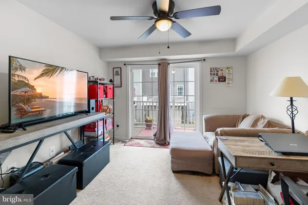 a view of a livingroom with furniture and a flat screen tv
