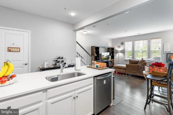 a view of living room kitchen island a sink a couch and a window