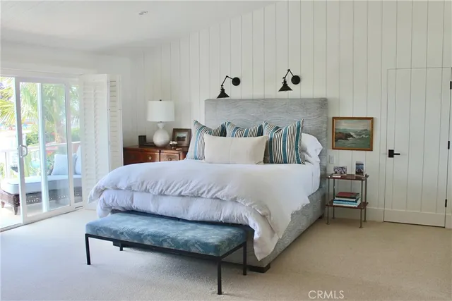 a bedroom with a bed and a lamp