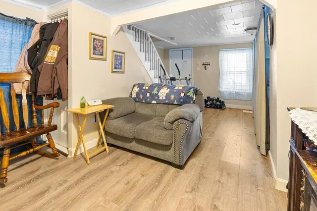 a bedroom with furniture and a wooden floor