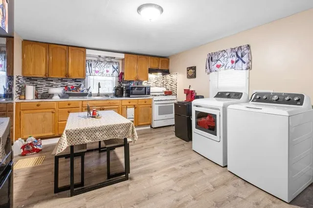 a open kitchen with a stove top oven sink and cabinets