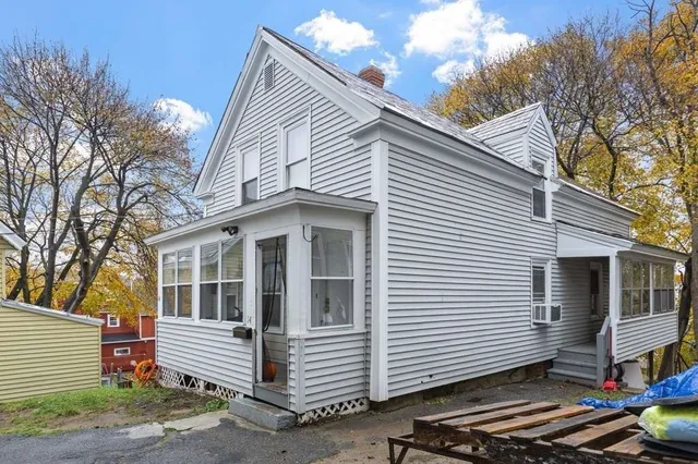 a view of a white house with a sink and large windows