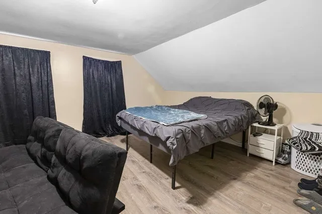 a bedroom with furniture and a rug