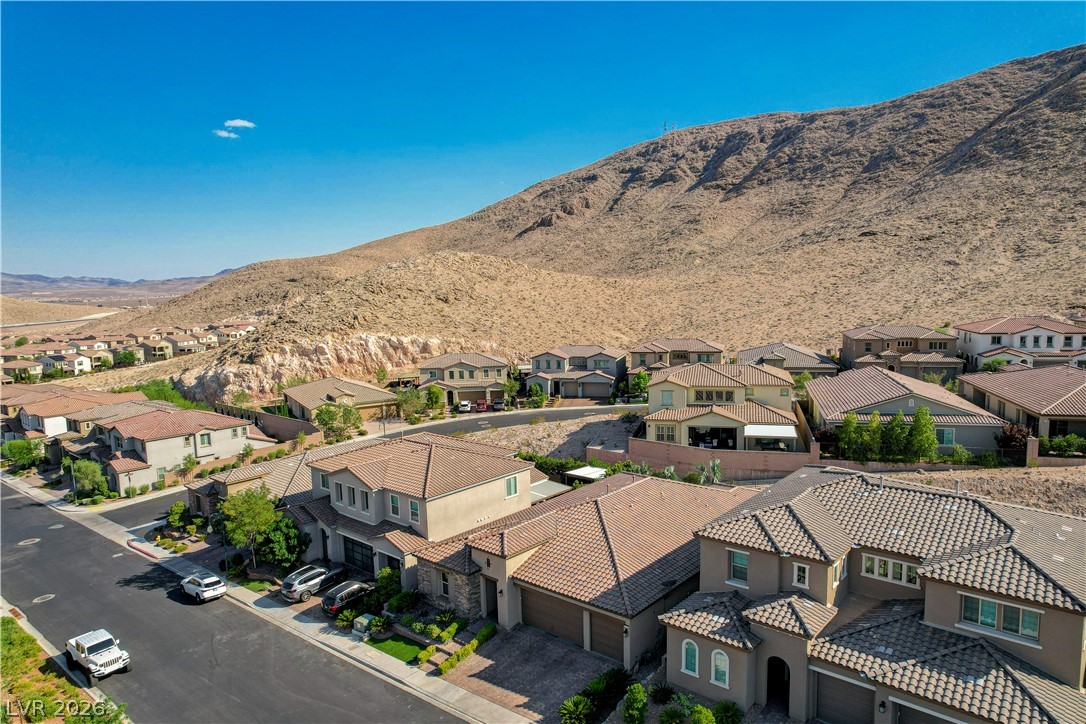 3943 Reyes Avenue Las Vegas, NV 89141 - Photo 63 of 95 Hillside residences with terracotta roofs blend seamlessly into the desert landscape.
