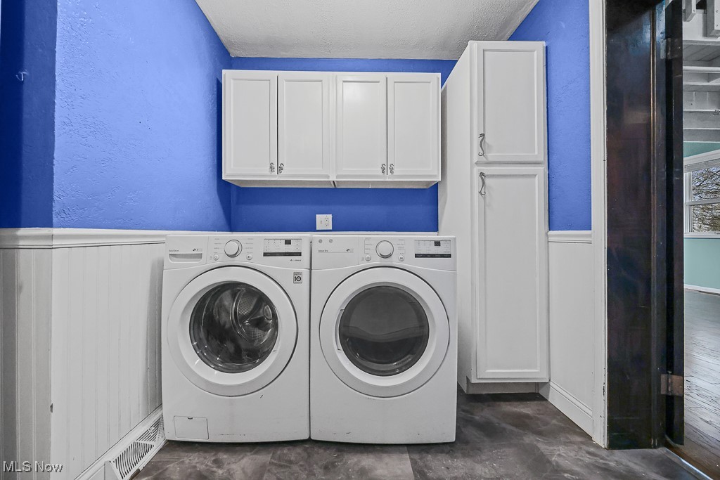 3401 Waterloo Road Mogadore, OH 44260 - Photo 19 of 50 Laundry room featuring a wainscoted wall, a textured wall, cabinet space, and independent washer and dryer