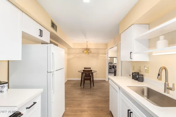 a kitchen with a refrigerator a sink and a refrigerator