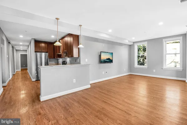 a view of a kitchen with a sink and a living room