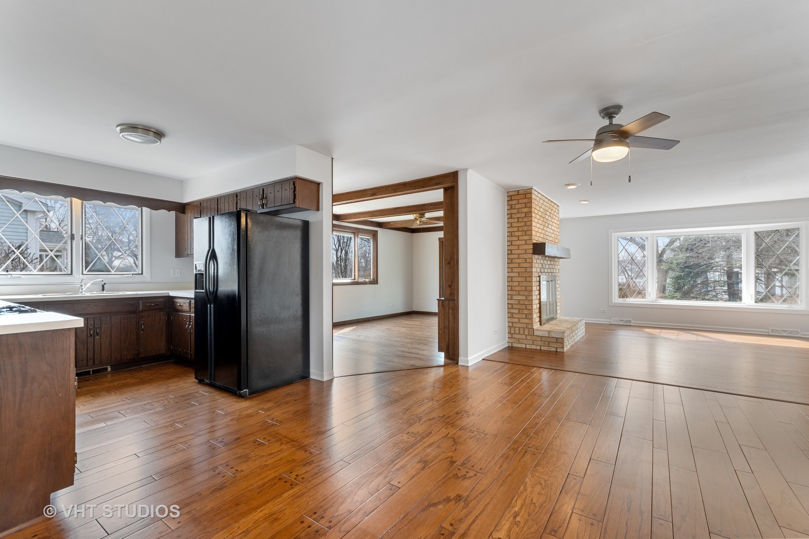 972 West Bauer Road Naperville, IL 60563 - Photo 3 of 32 a view of a kitchen with a sink refrigerator and wooden floor