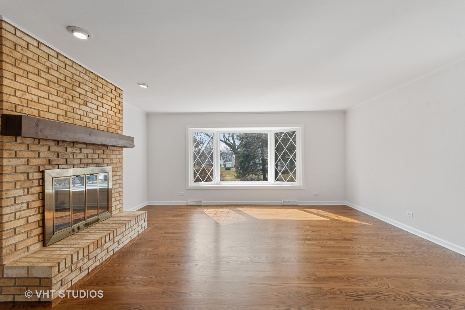 972 West Bauer Road Naperville, IL 60563 - Photo 8 of 32 a view of empty room with wooden floor and fireplace