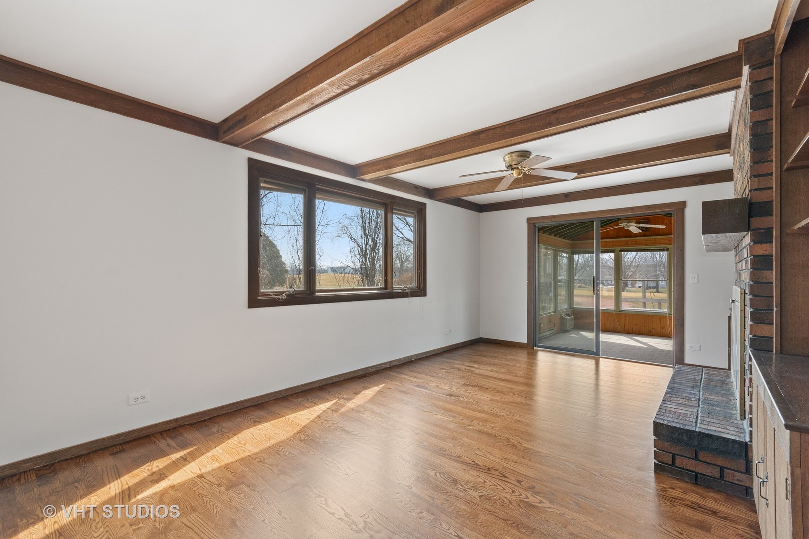 972 West Bauer Road Naperville, IL 60563 - Photo 9 of 32 a view of an empty room with wooden floor and a window