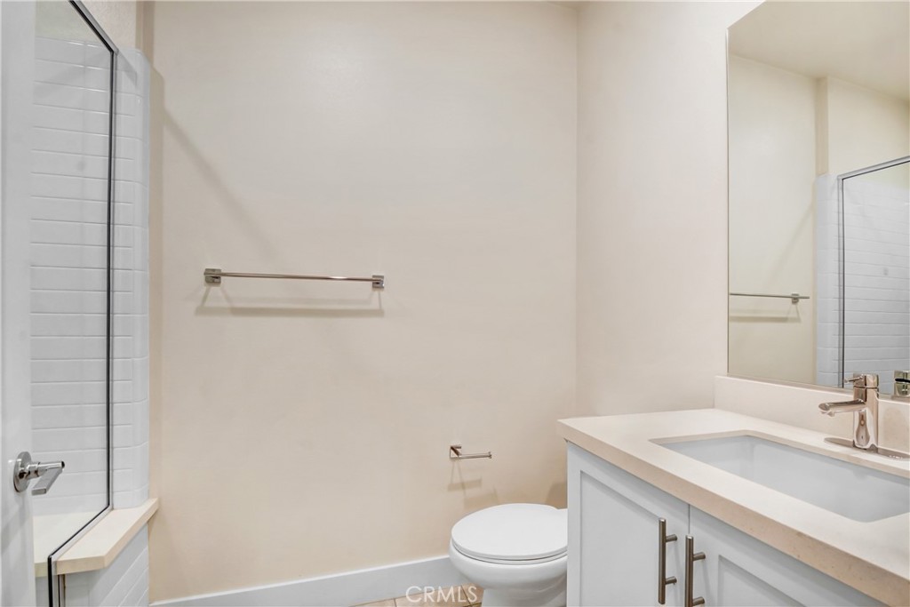 181 Novel Irvine, CA 92618 - Photo 11 of 22 a bathroom with a granite countertop toilet a sink and a mirror